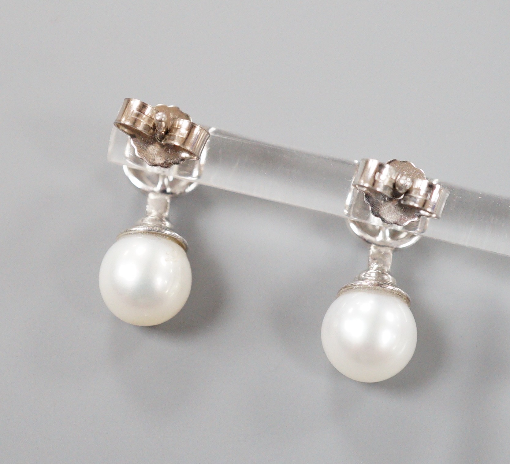 A modern pair of 198ct white gold cultured pearl and single stone collet set diamond ear studs, 19mm, gross weight 5.4 grams.